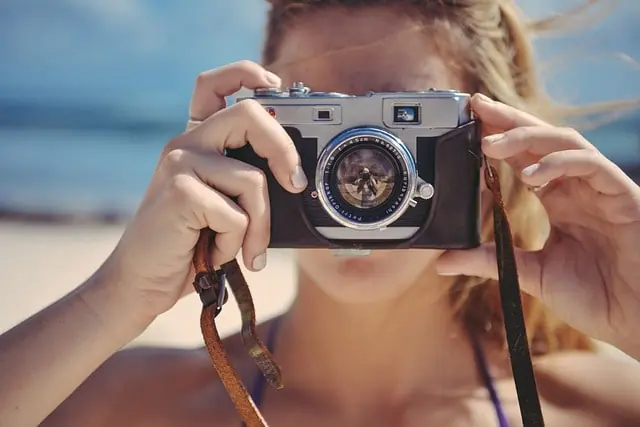 Content creator taking a photo at the beach